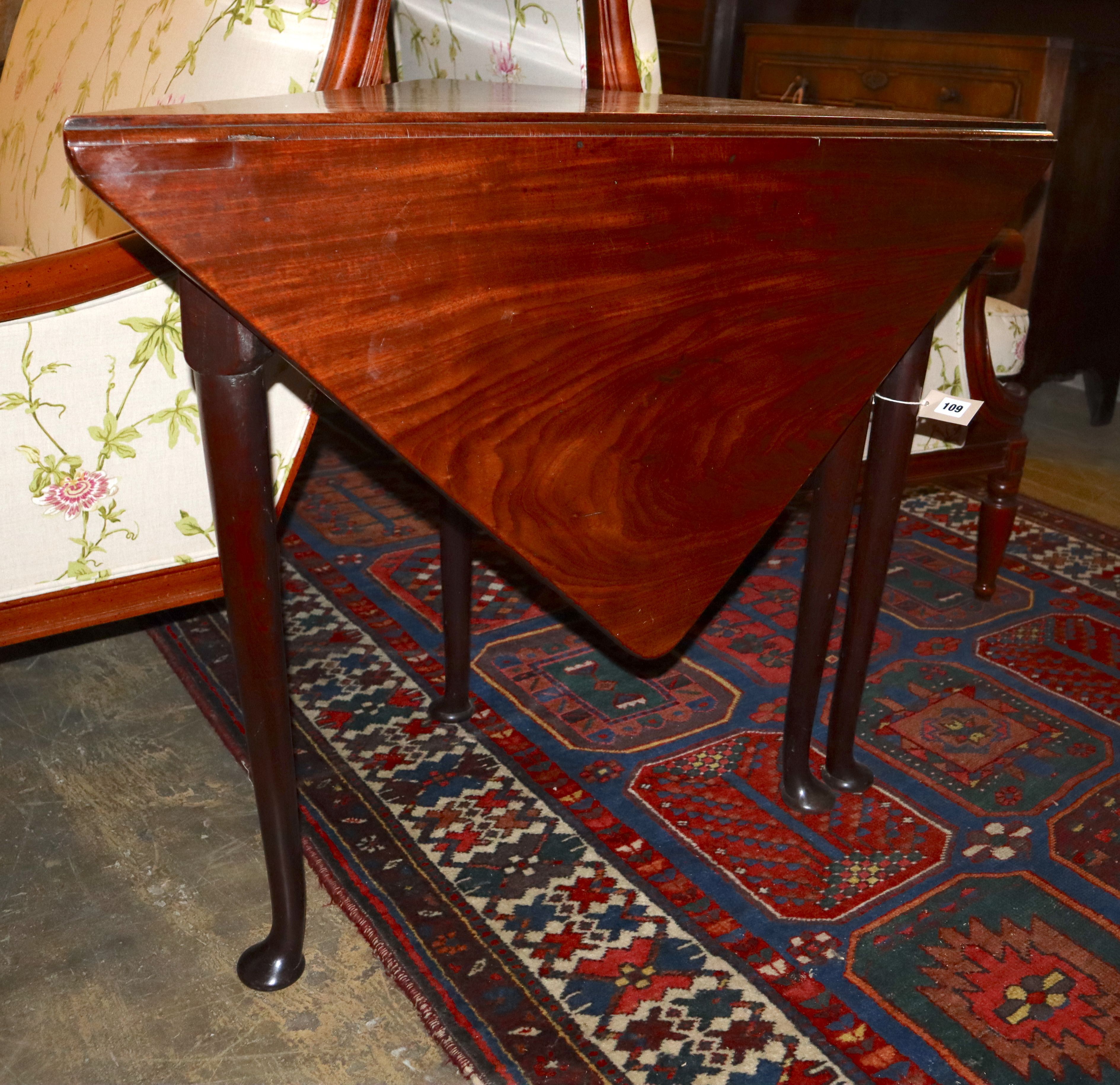 A George III mahogany triangular drop-leaf table, width 89cm, depth 46cm, height 72cm